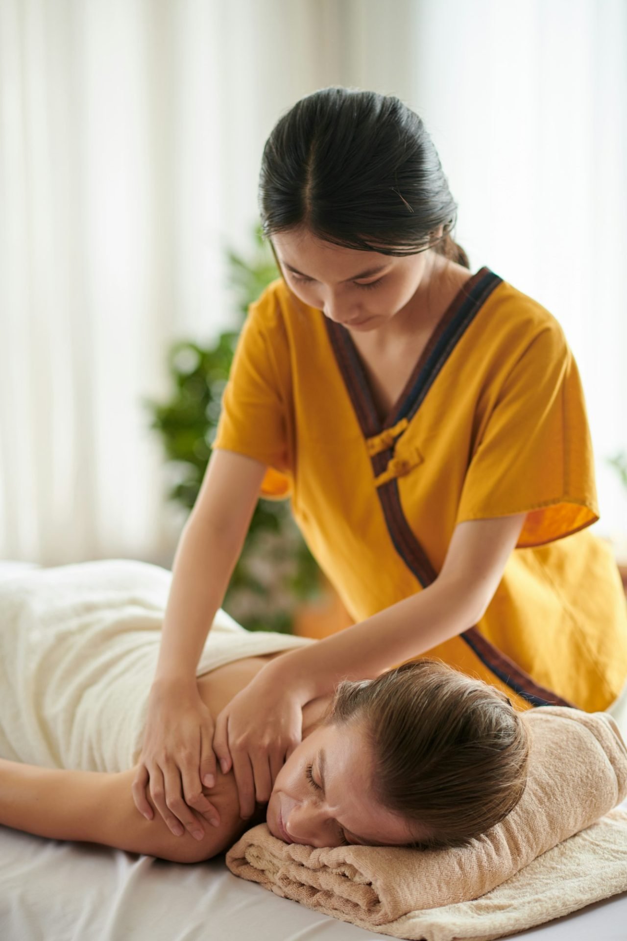 massaging-back-of-woman-in-spa-salon.jpg